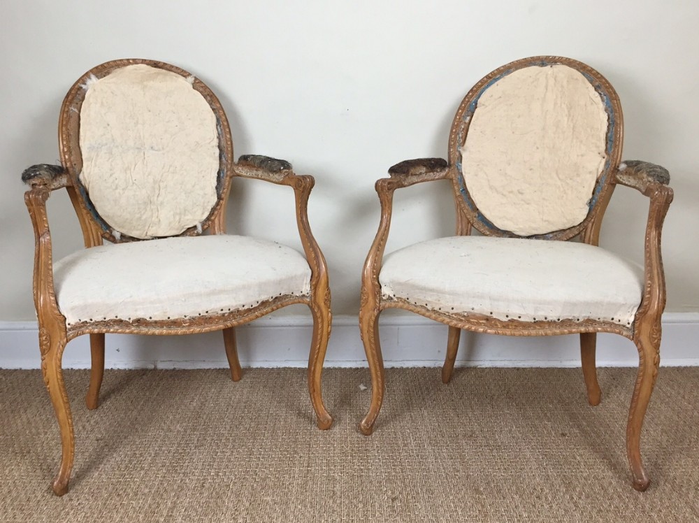 A pair of George 111 Hepplewhite period beech armchairs in the French taste circa 1775