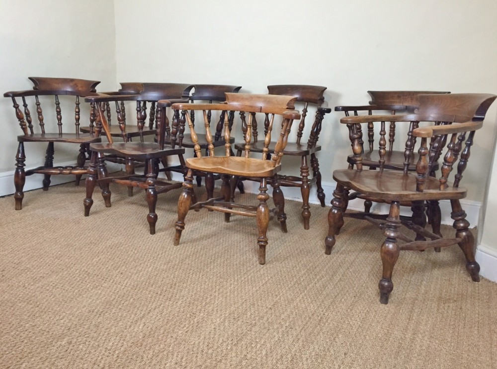 A harlequin set of eight Elm smokers bow Chairs mid to late 19th century