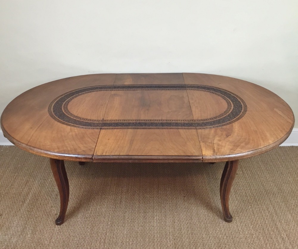 An Anglo Indian walnut extending circular dining table by the Bombay Furniture Company circa 1910 
