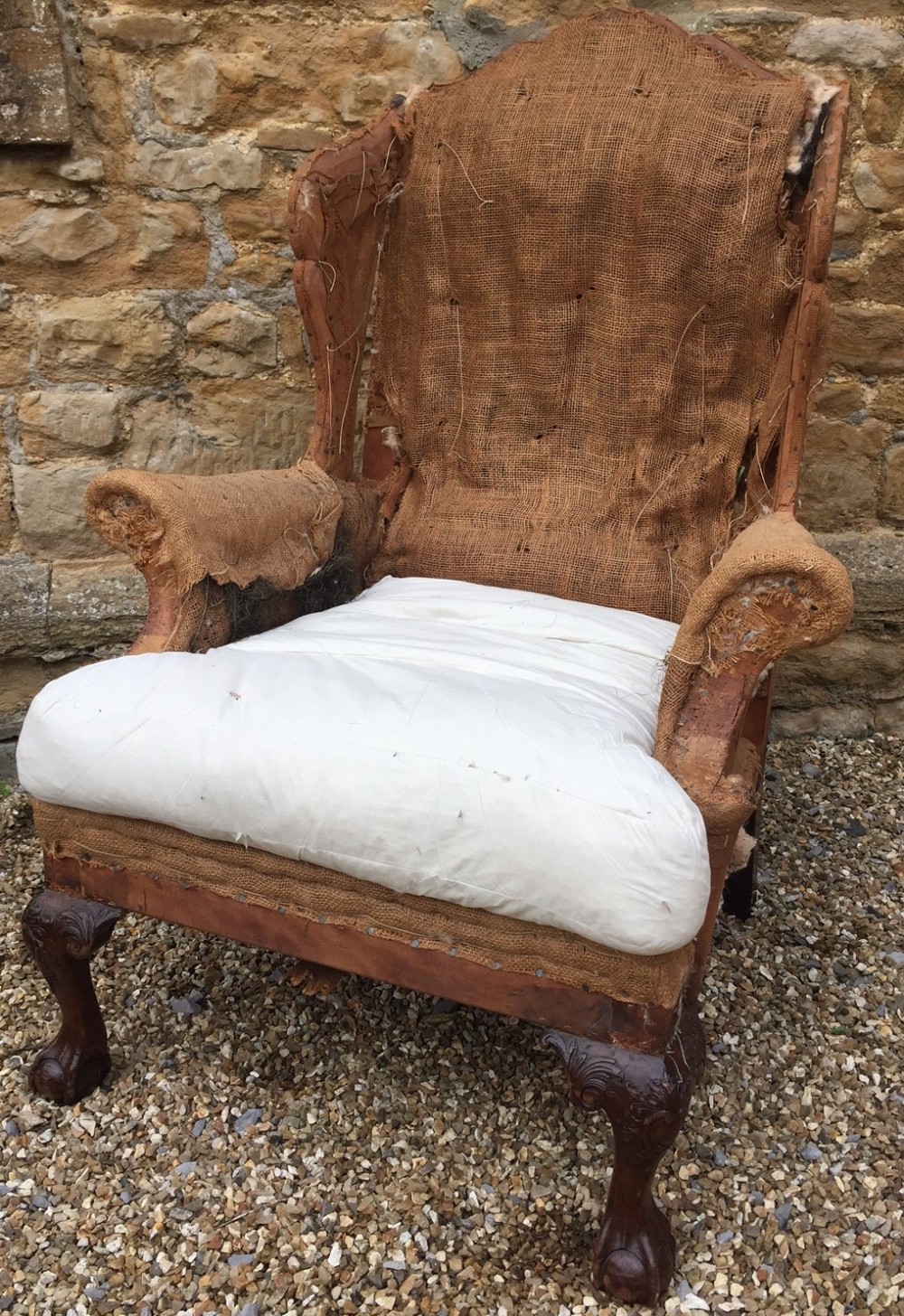A large late 19th century mahogany wing armchair in George 11 style