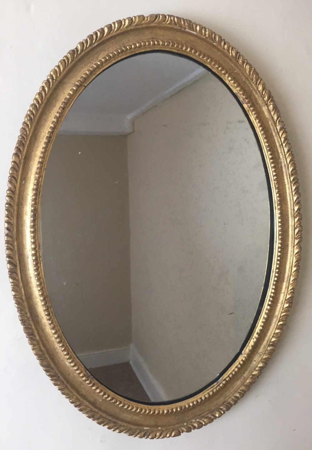 A George 111 gilt oval mirror circa 1800