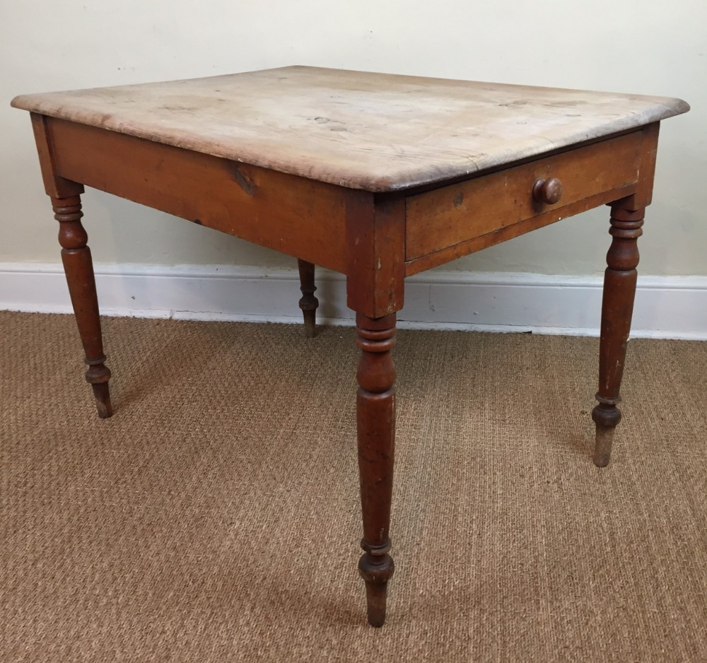 A Victorian pine kitchen table c 1880  with scrub top on original painted turned legs 