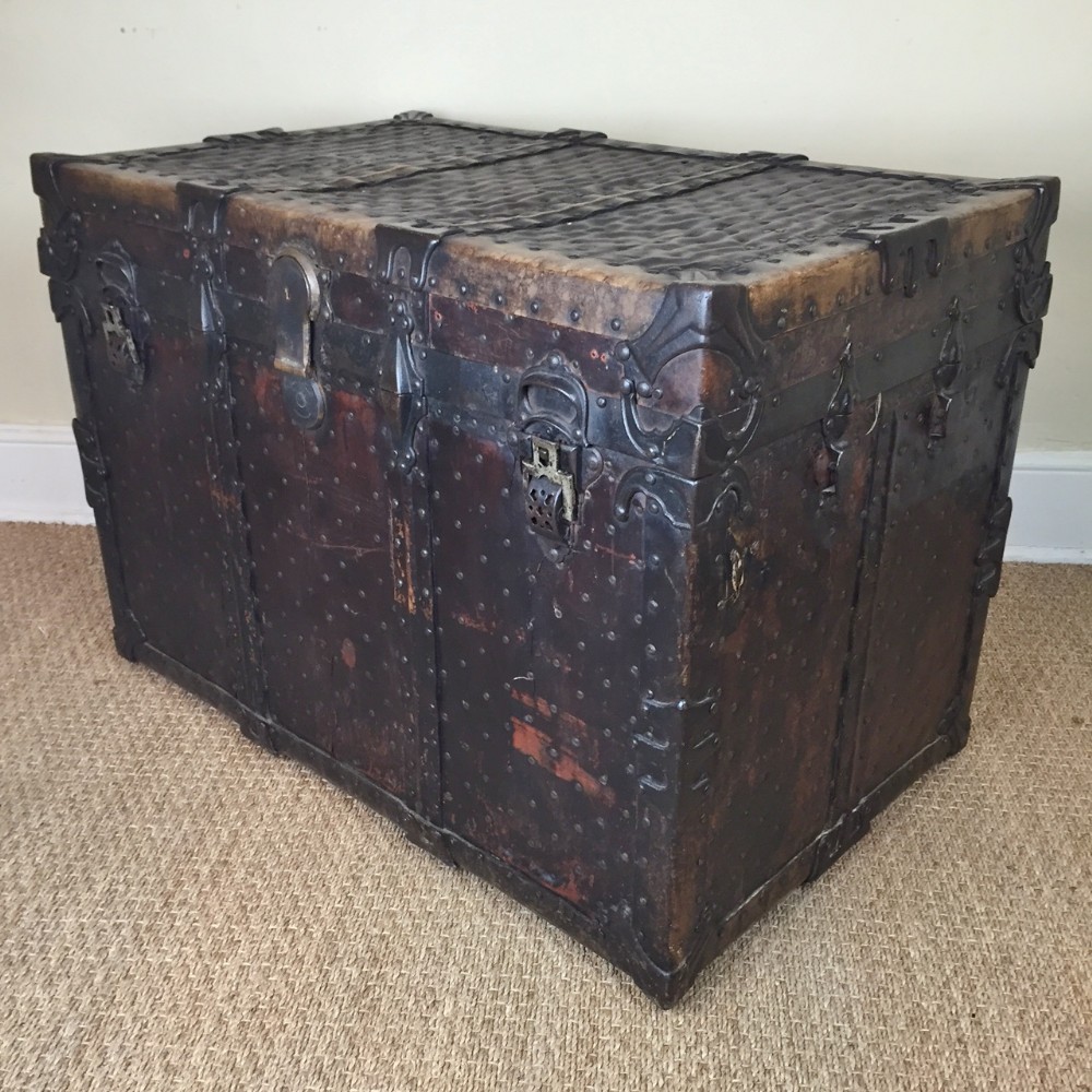 An unusual 19th c leather brass and iron studded travelling trunk 