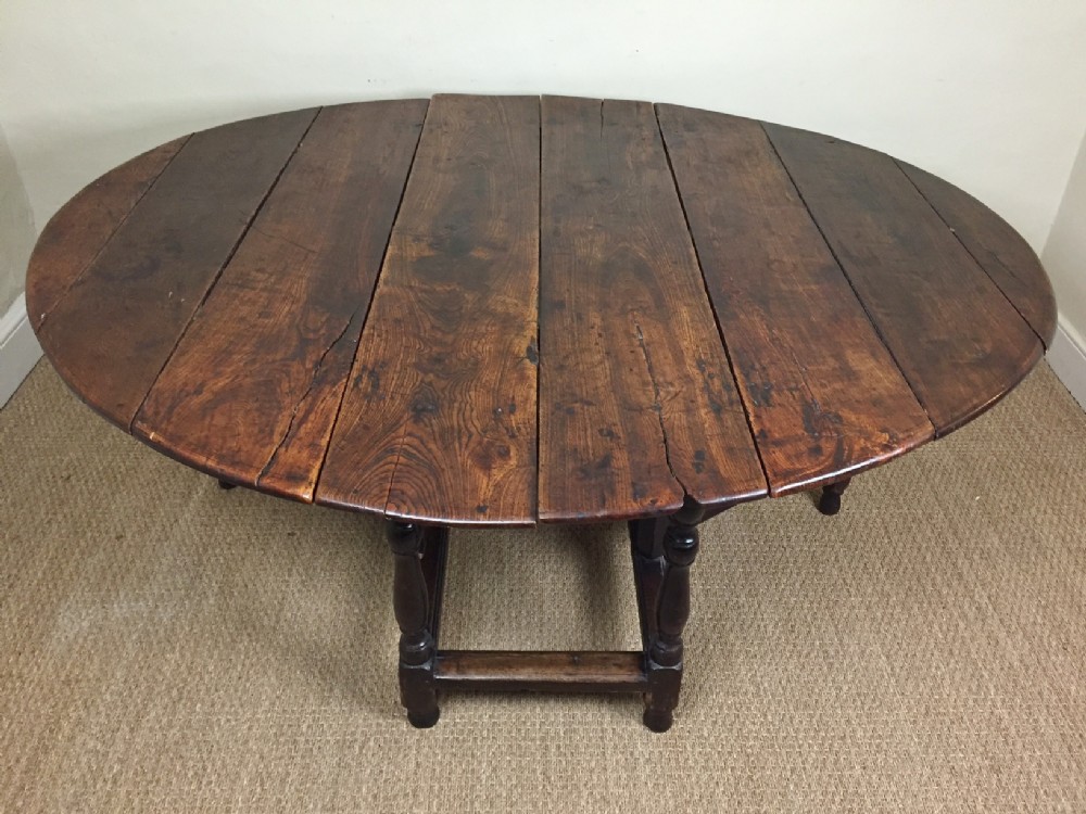 A large Queen Anne elm gateleg table circa 1710 