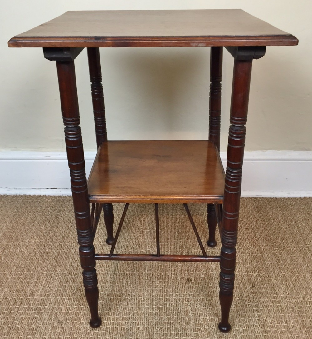 An Aesthetic movement walnut two tier table designed by E W Godwin circa 1880