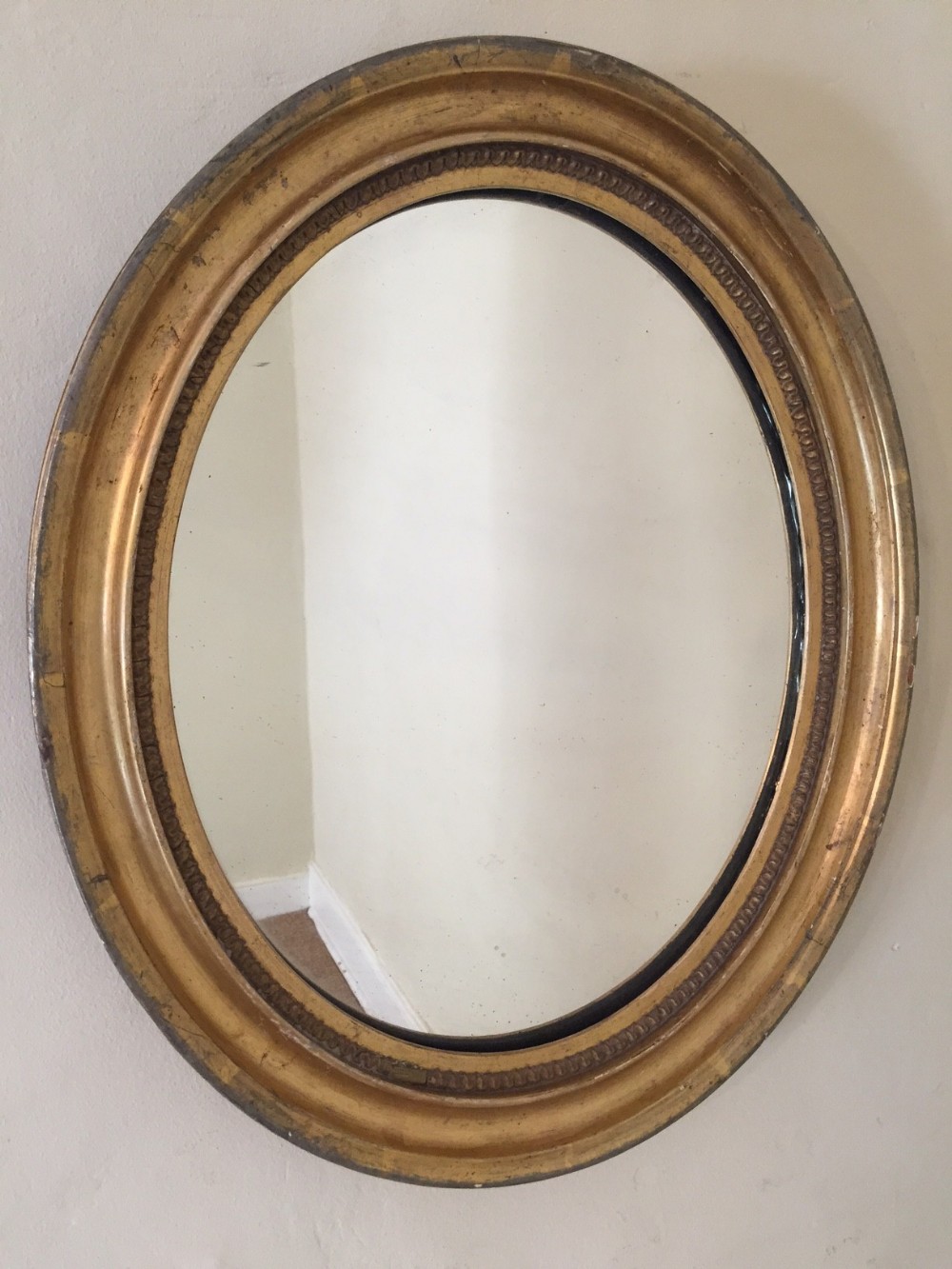 An English water gilt small oval mirror c 1870