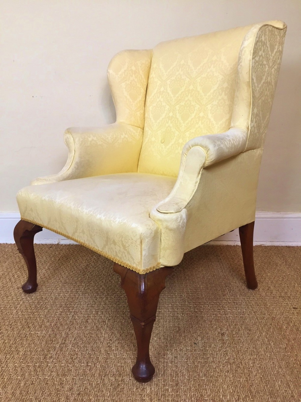 An early Georgian style walnut wing library armchair c 1910