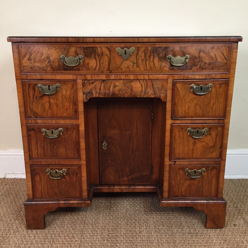 A small George 1 walnut kneehole desk circa 1725 