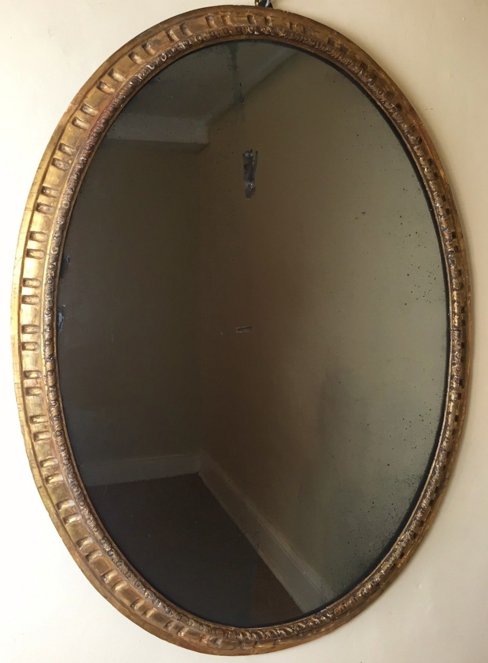 A George 111 carved wood oval gilt mirror c 1770 
