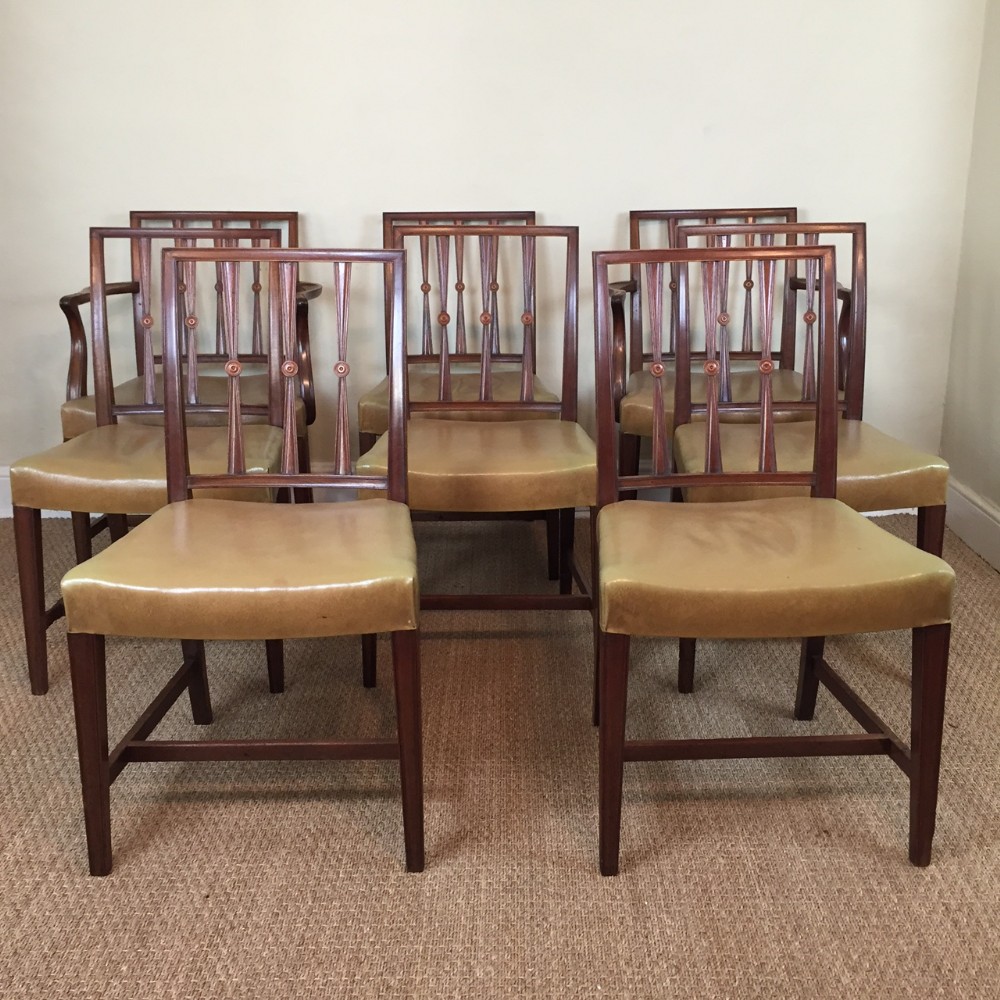 A set of eight Sheraton style mahogany dining chairs by Waring and Gillow circa 1910