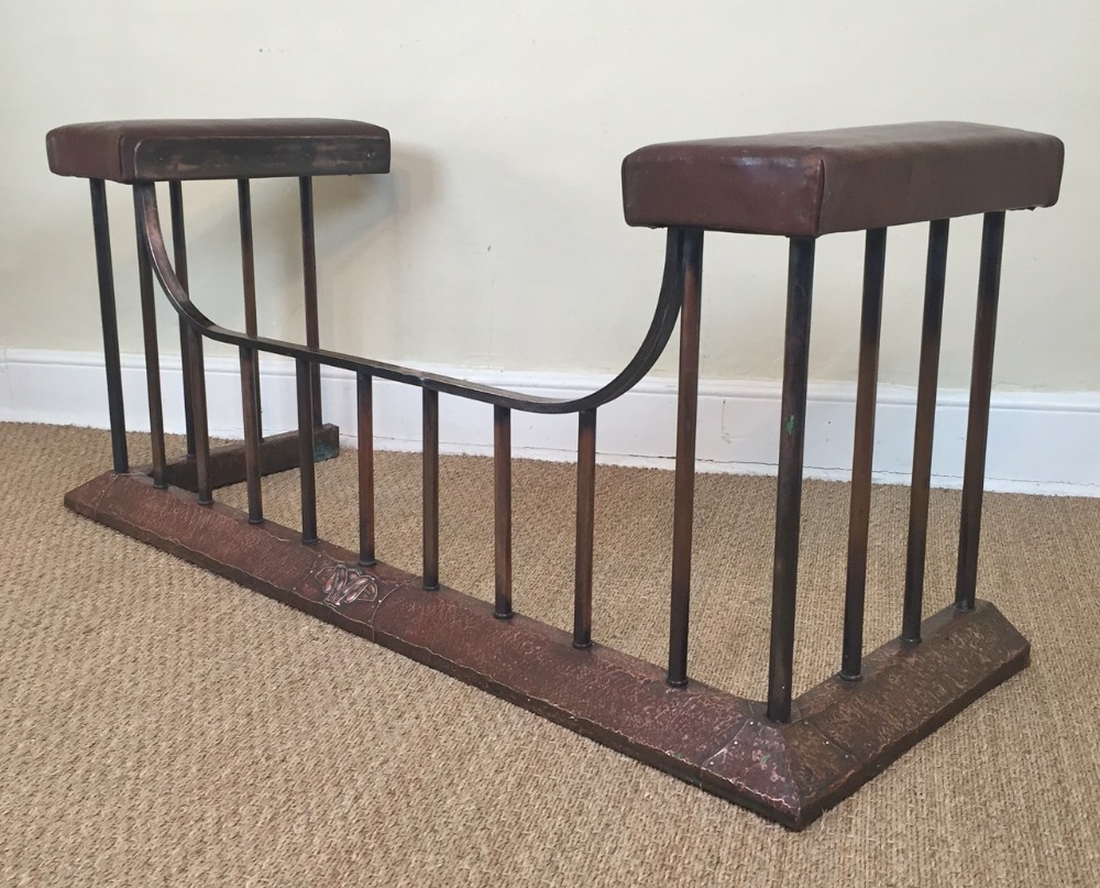 An Edwardian brass and copper club fender c 1910