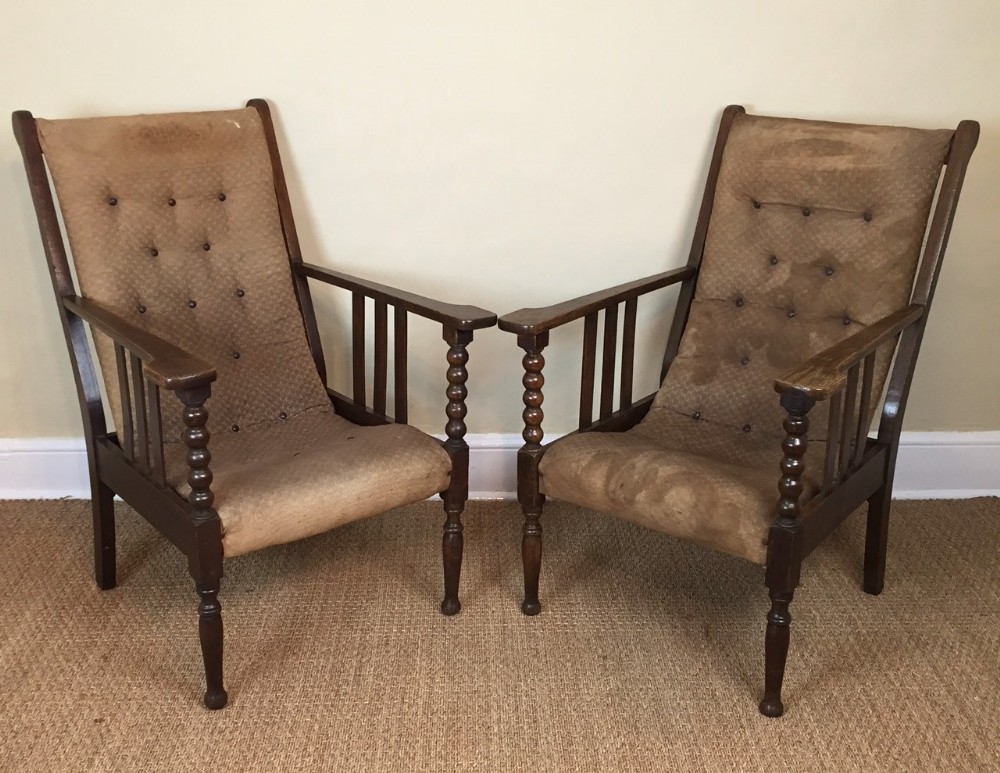 A pair of Edwardian oak bobbin armchairs c 1910