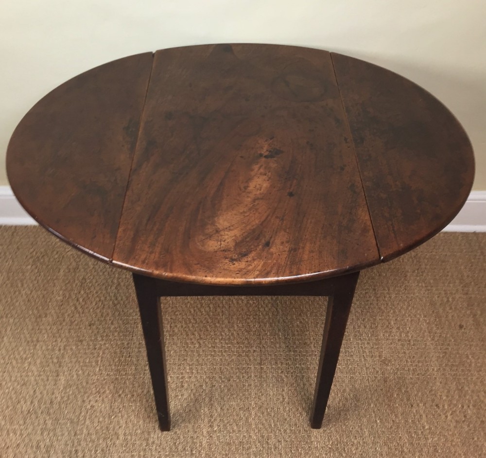 A late 18th century mahogany oval drop flap table c 1780