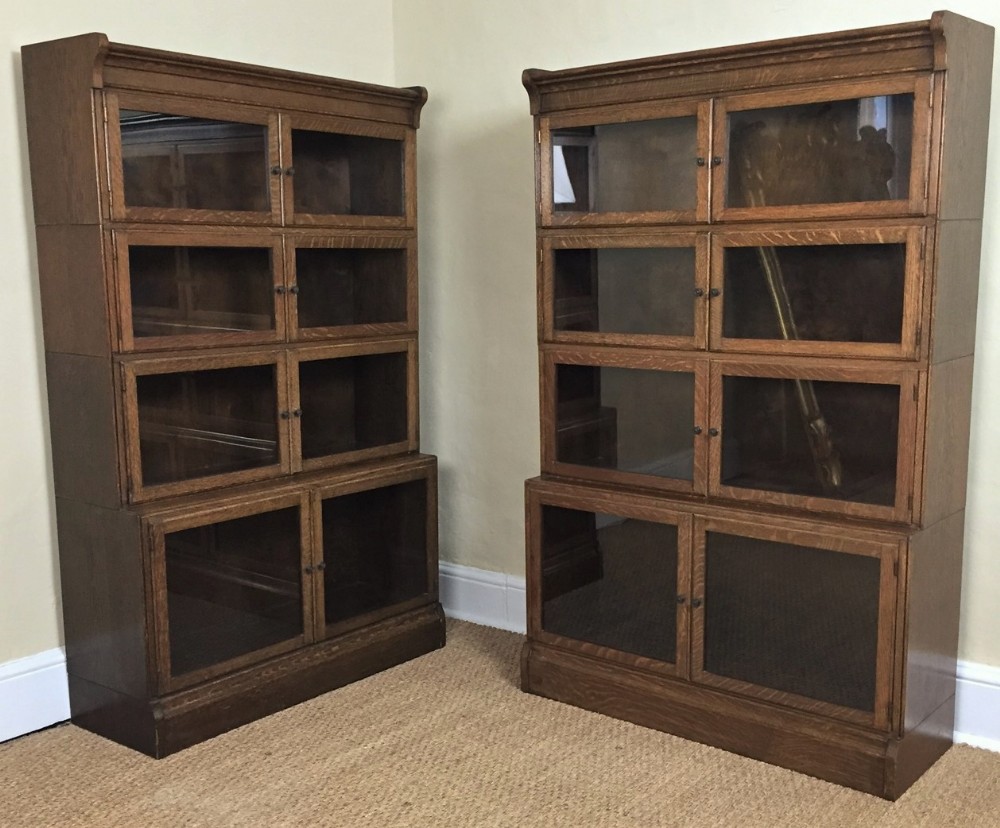 A pair of oak glazed Minty 4 section bookcases circa 1925