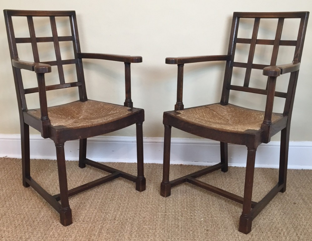 A pair of Heals oak lattice back armchairs circa 1910