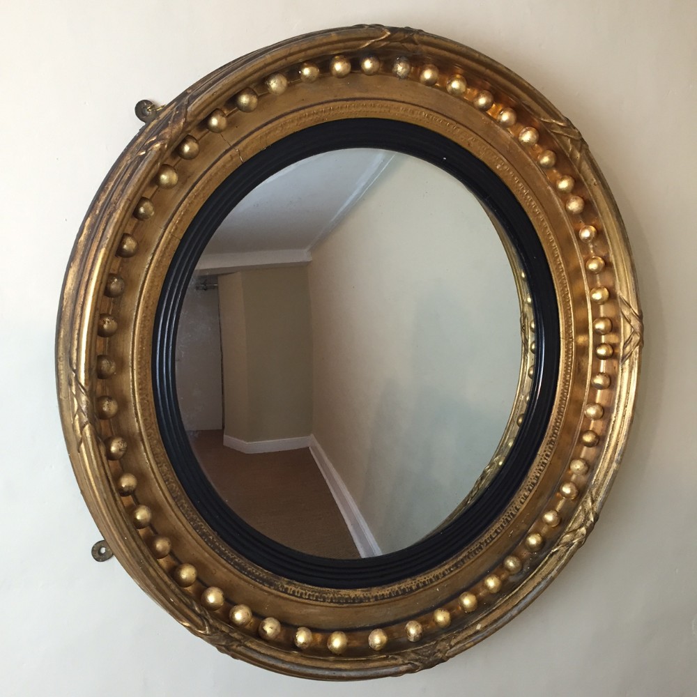 A large Regency gilt convex mirror circa 1820 