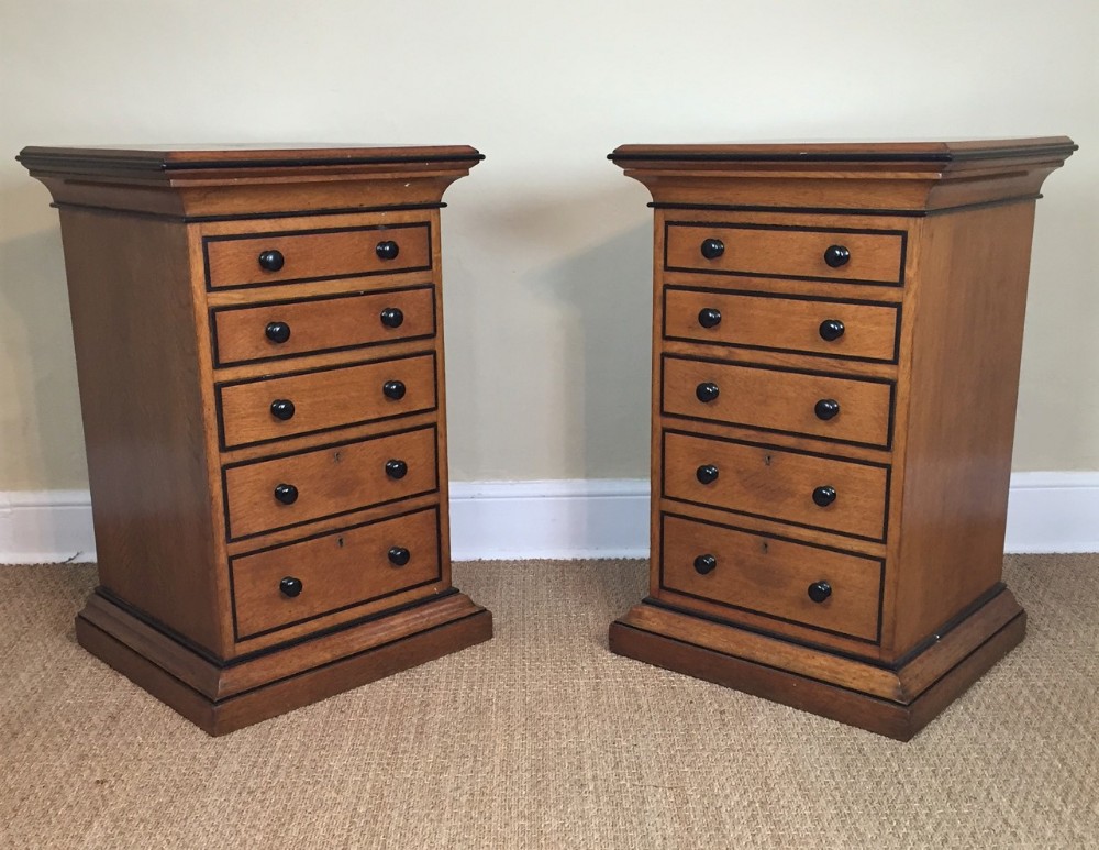 A pair of Victorian oak and ebony pedestal chest of drawers circa 1870
