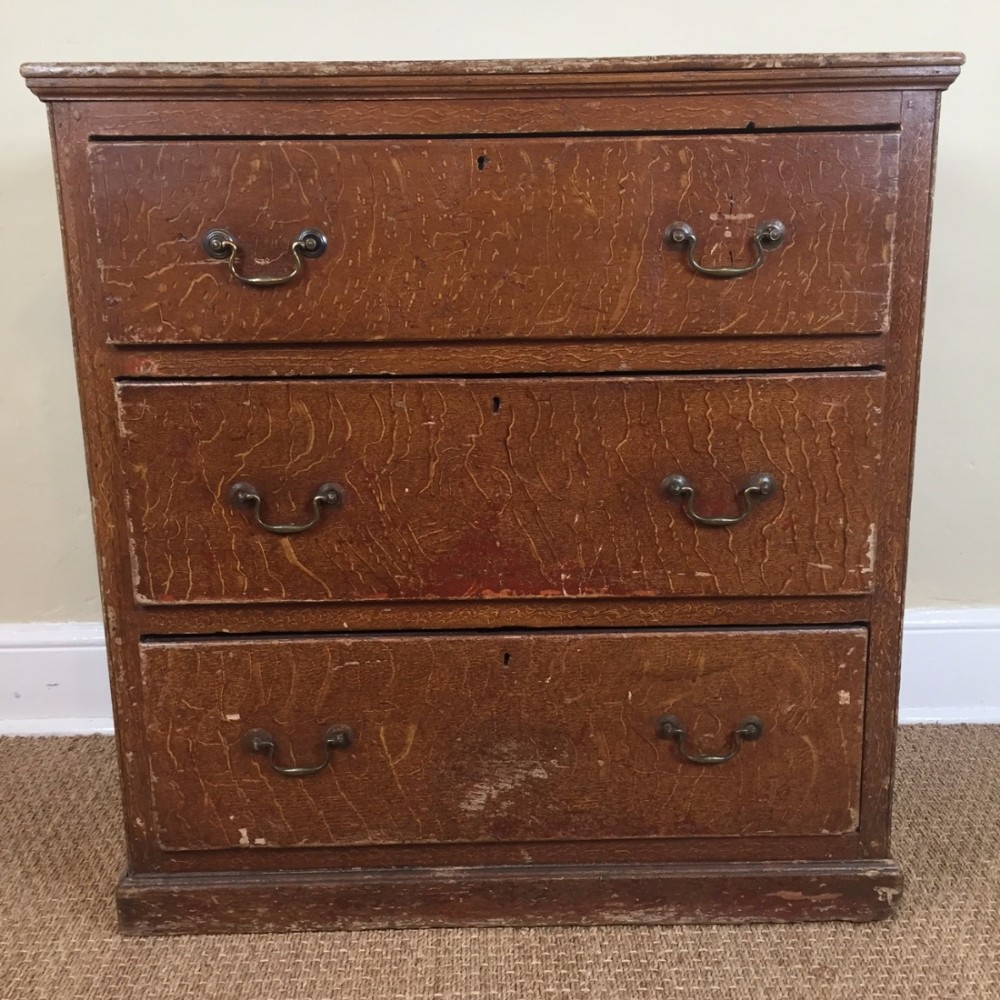 A late Georgian painted pine simulated oak small chest of drawers circa 1830