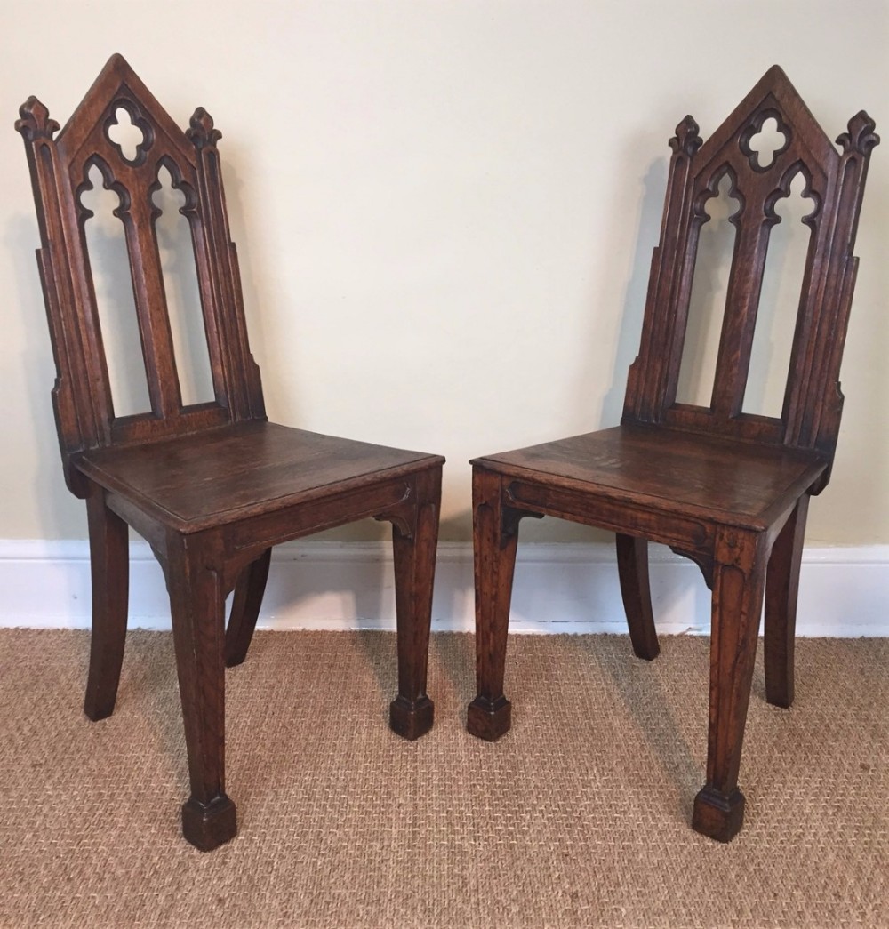 A pair of William IV oak Gothic hall chairs circa 1835 
