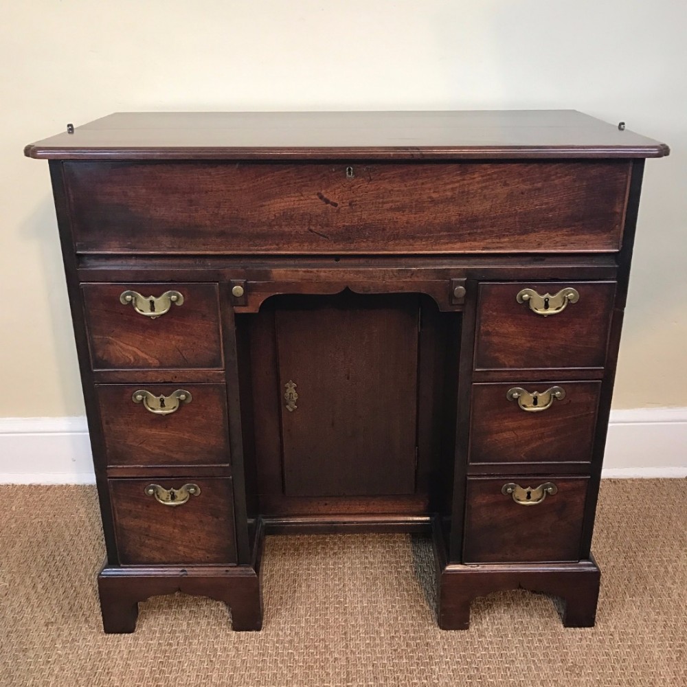 An unusual George 11 mahogany secretaire kneehole desk circa 1745