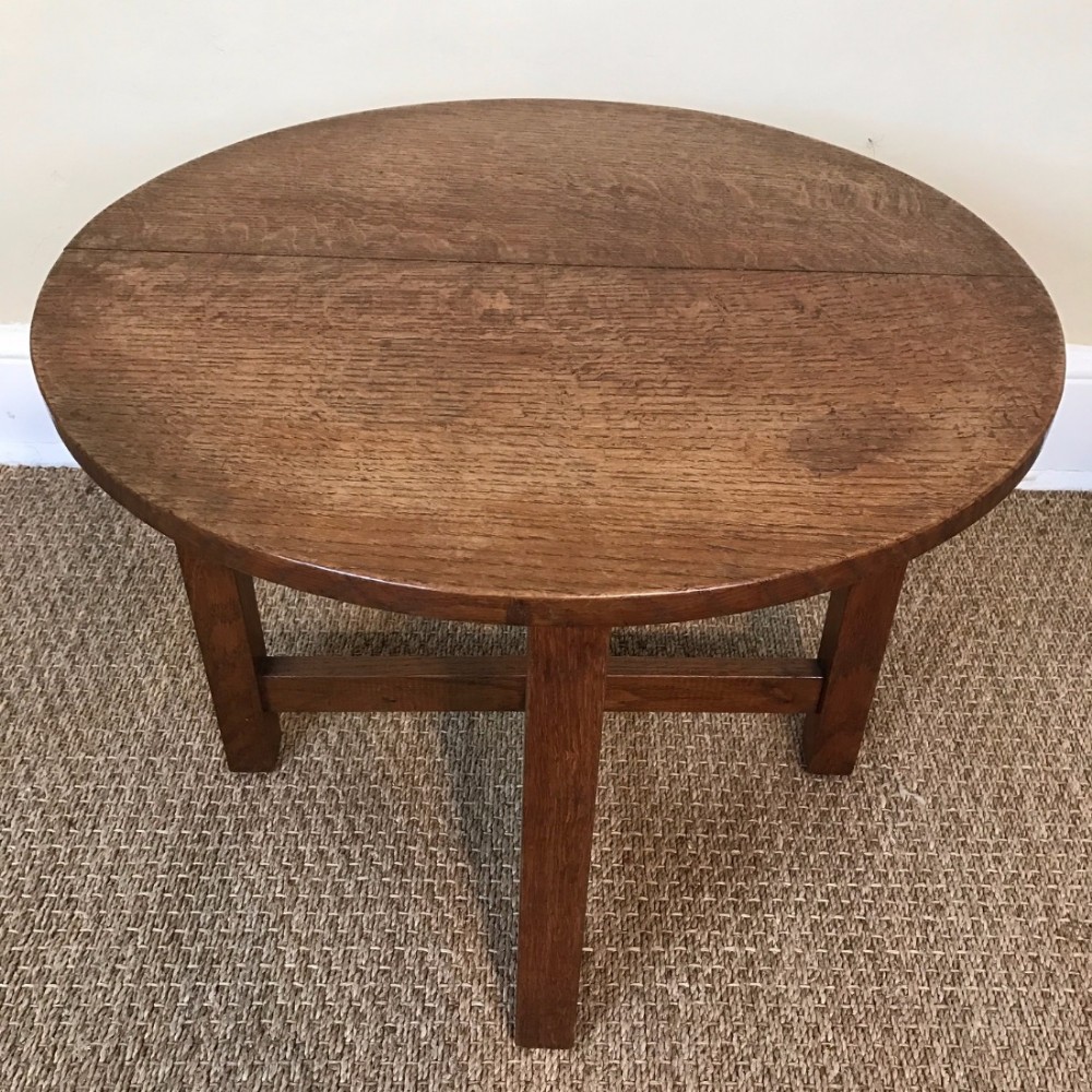 A Cotswold school oak circular coffee table circa 1925