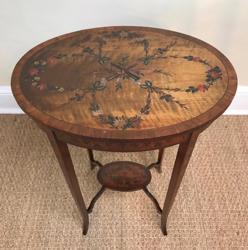 An Edwardian satin wood and painted oval lamp table circa 1910