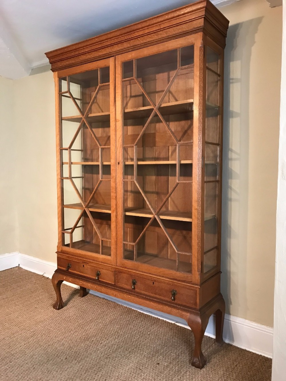 An Edwardian honey oak display cabinet c 1910 