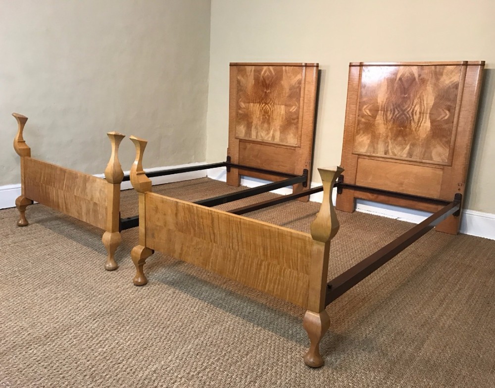 A pair of English Art Deco walnut and ripple maple single beds circa 1925 