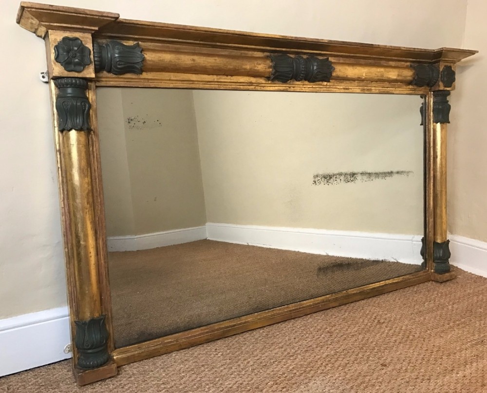 A large Regency gilt and green painted overmantel mirror circa 1815