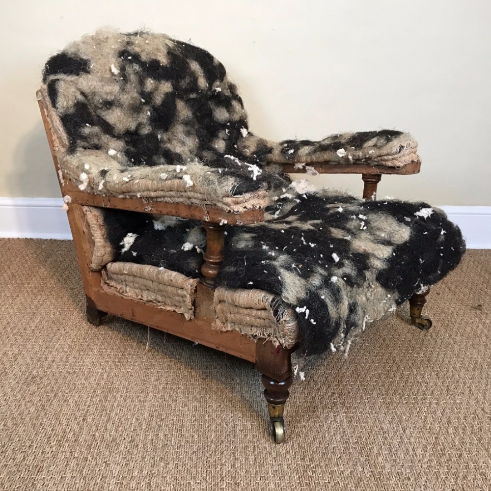 A Holland and Sons walnut open armchair circa 1870 for recovering.