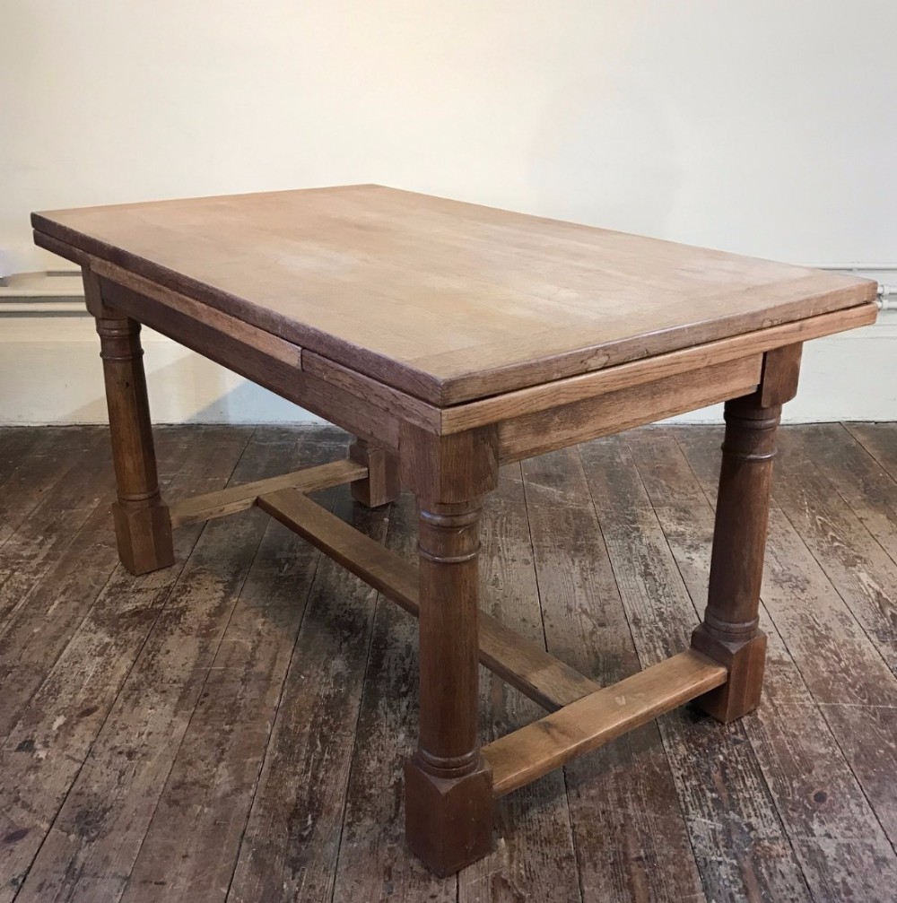 An Arts and Crafts oak draw leaf table circa 1930