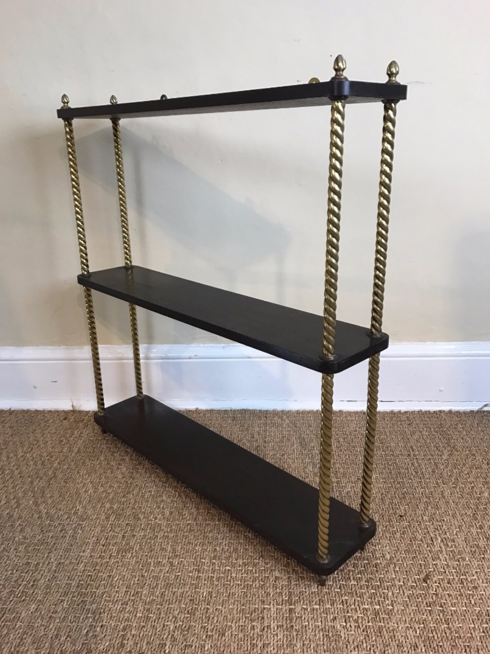 A set of mid 19th century mahogany and brass hanging wall shelves.