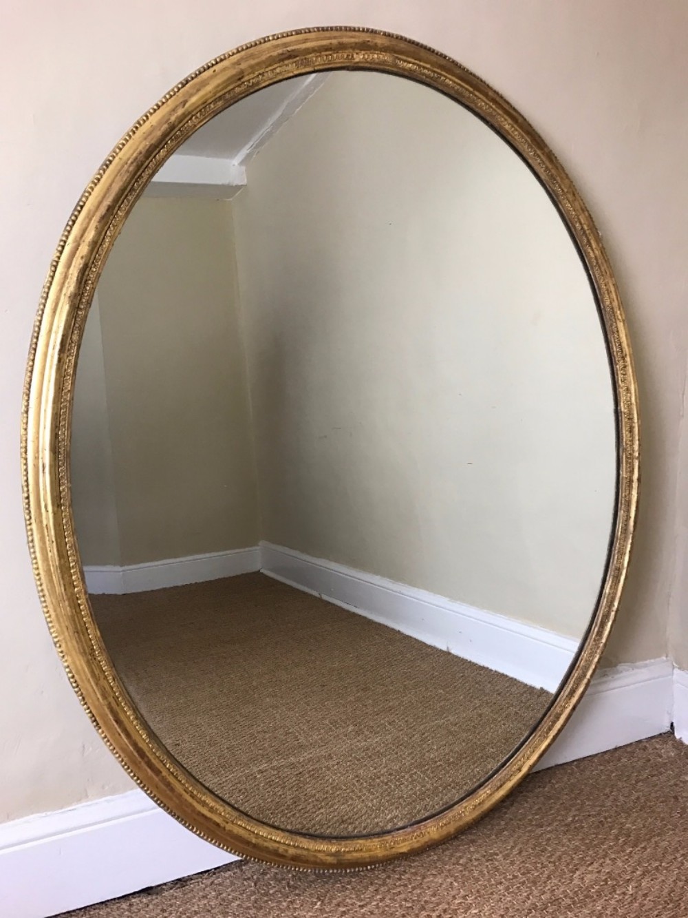 A large mid Victorian gilt oval mirror circa 1860