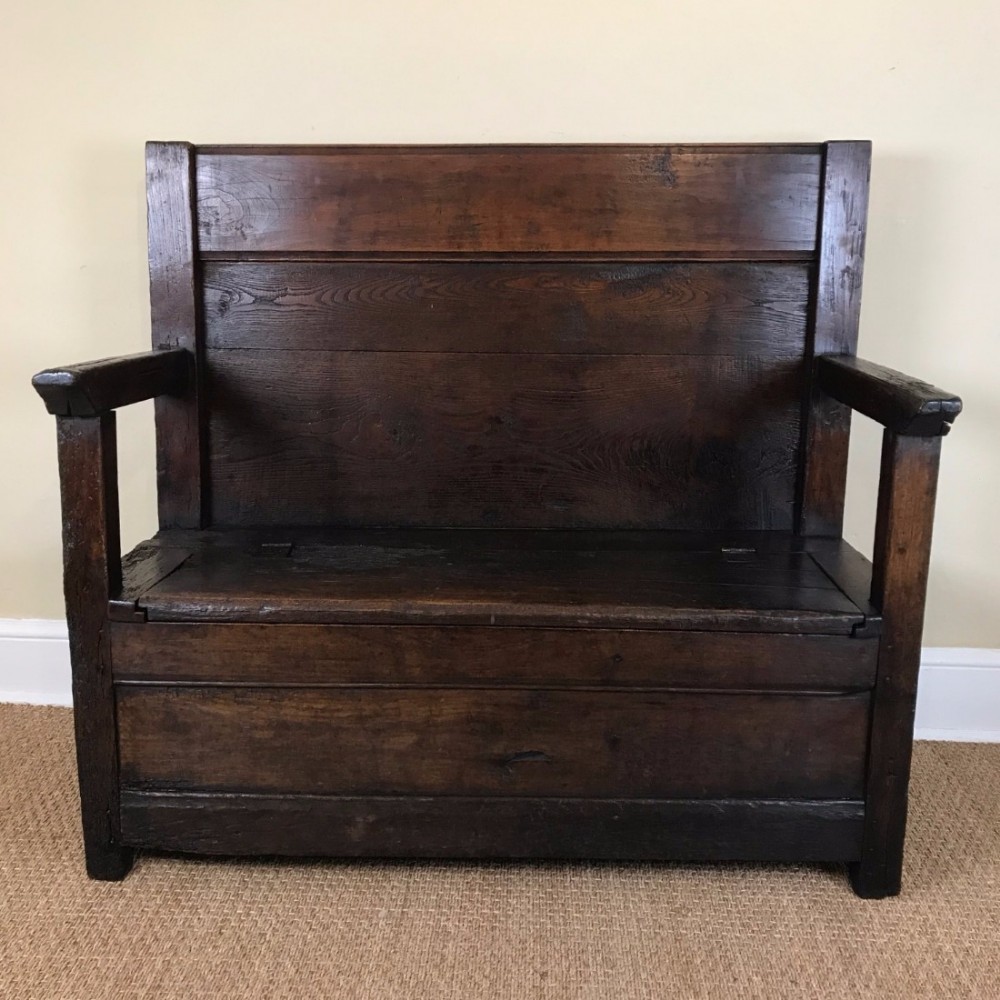An early 19th century Somerset ash and Elm box settle.