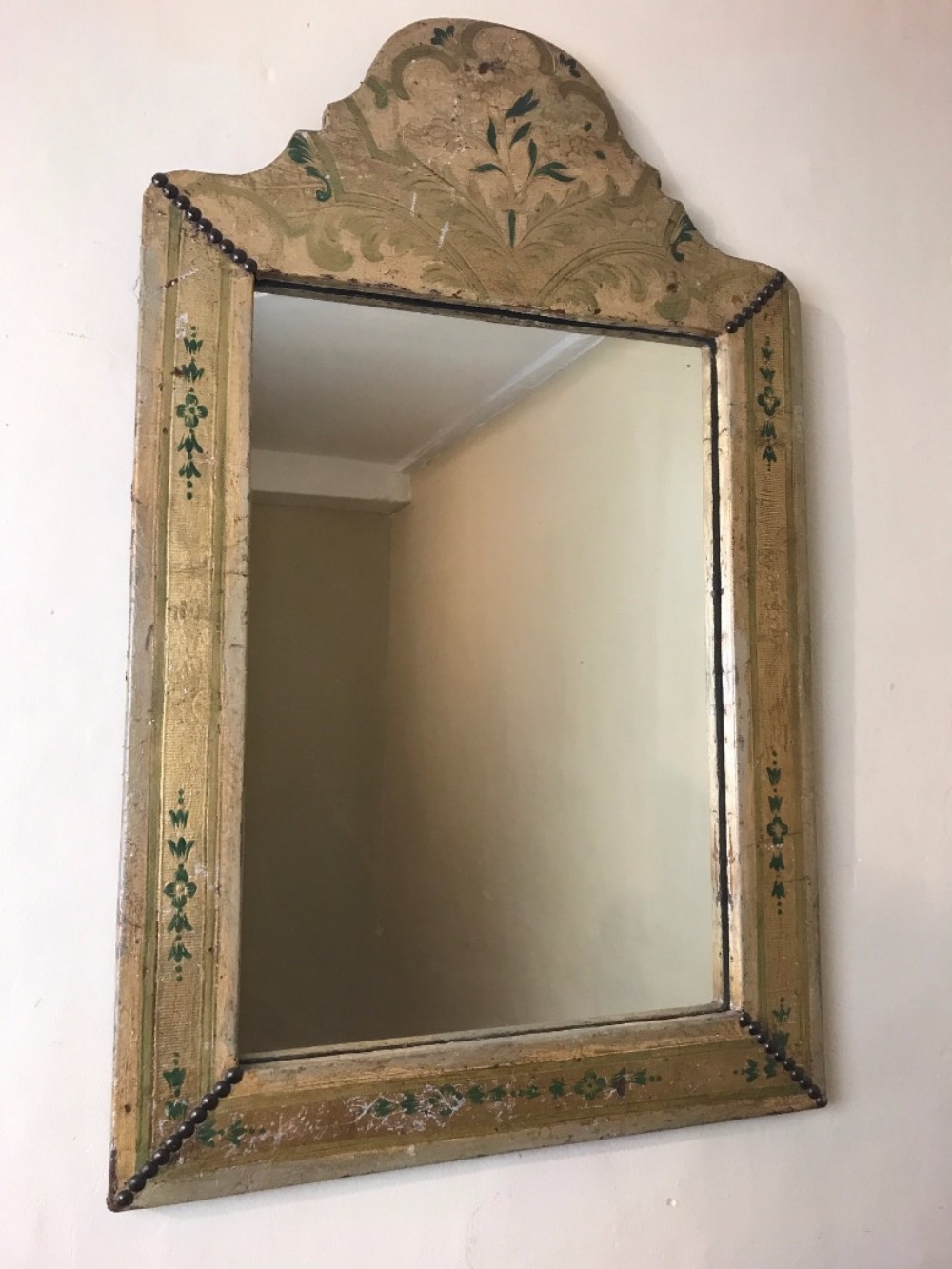 An Arts and Crafts Leather and gilt arched mirror circa 1900.