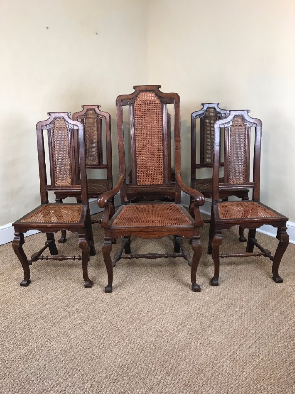 A rare set of 7 James II oak and caned dining chairs circa 1685
