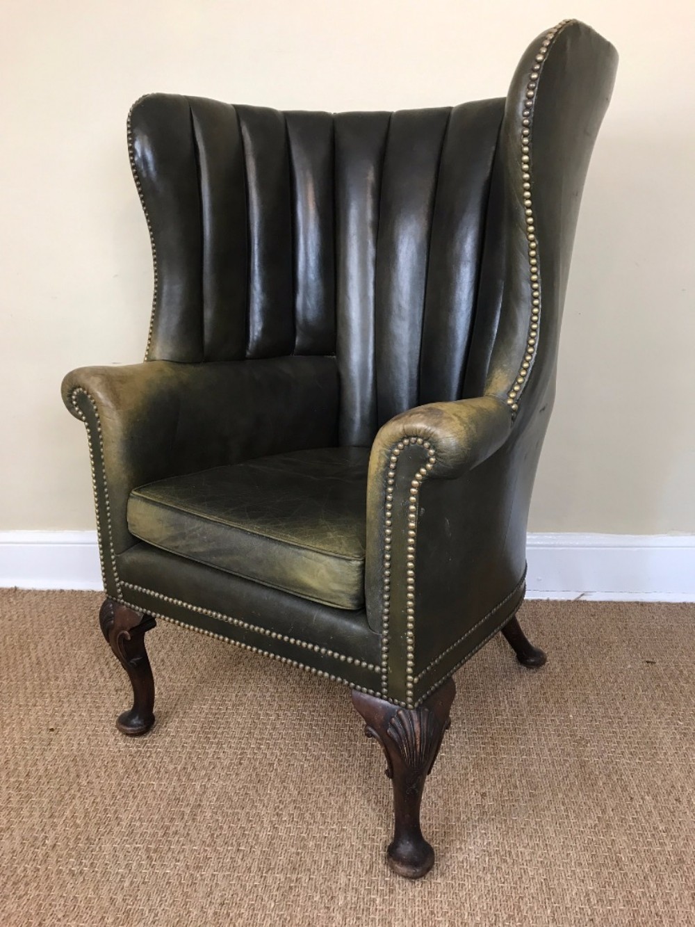 An Edwardian mahogany barrel back armchair circa 1910 in lovely old green leather