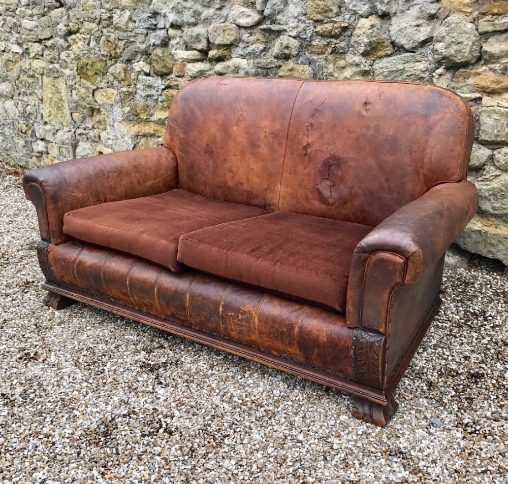 A leather and oak 2 seater sofa circa 1925 
