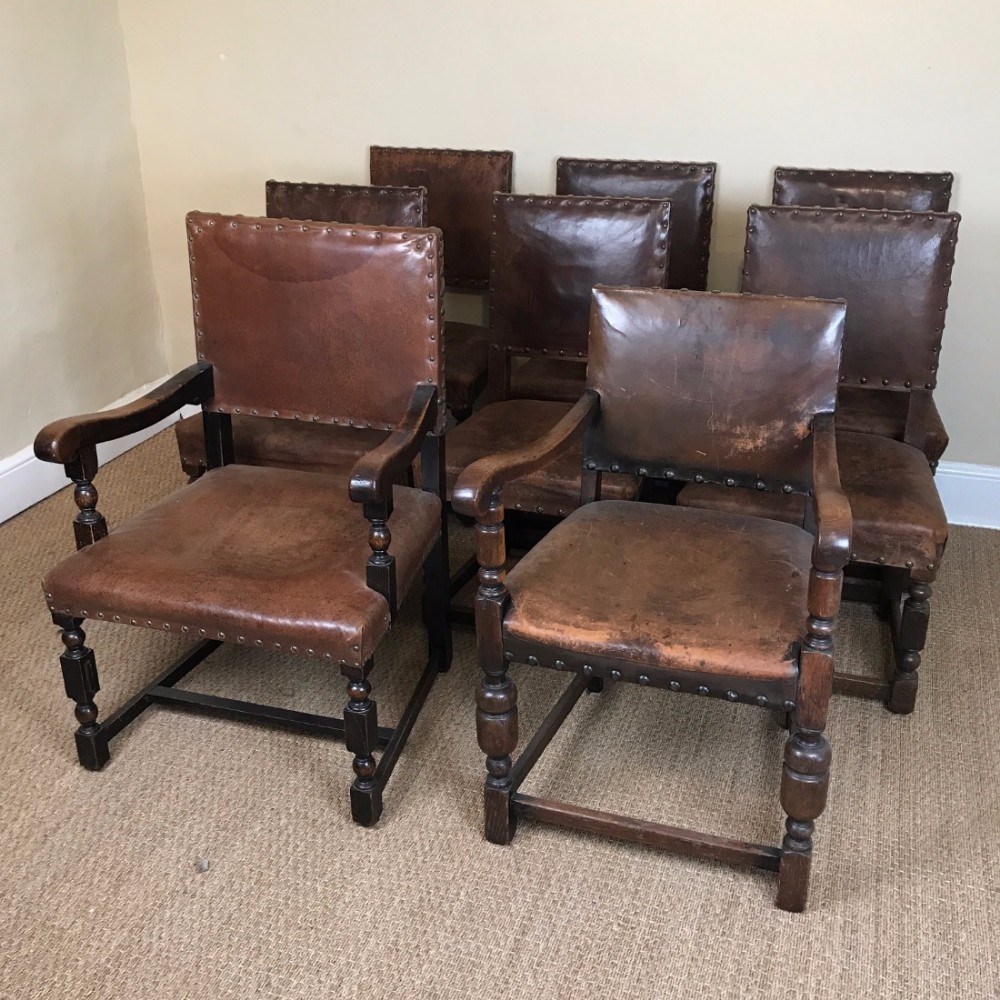A matched set of eight Liberty's oak and leather dining chairs circa 1910