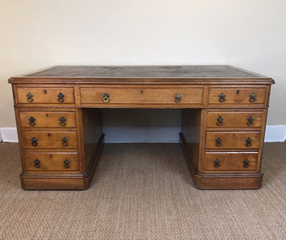 A Victorian oak partners desk circa 1875 in the Gothic style