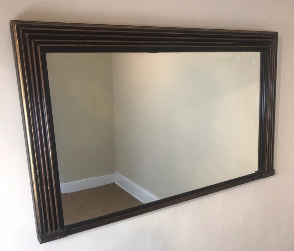 A small late Regency gilt and ebonised overmantel mirror circa 1830 