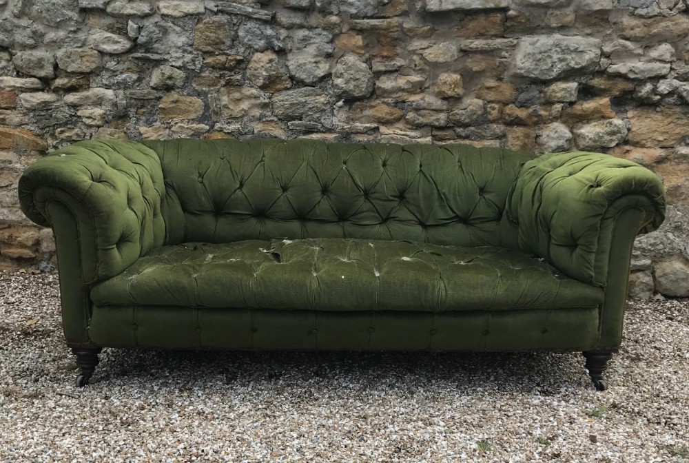 A large Victorian mahogany Chesterfield circa 1880 on turned legs brass cappings and casters.