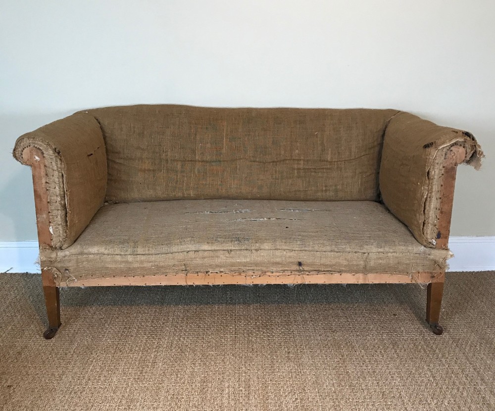 An Edwardian small sofa c 1910 on square tapering legs 
