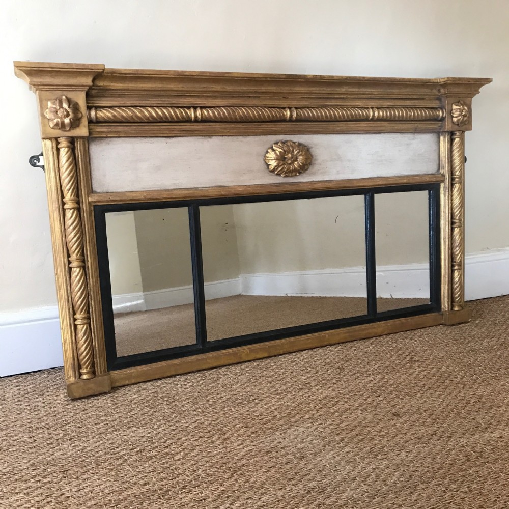 A late Regency painted and gilded overmantel mirror circa 1830
