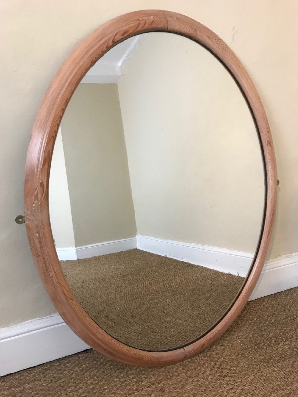 A good sized English pine oval mirror circa 1840 with original silvery plate