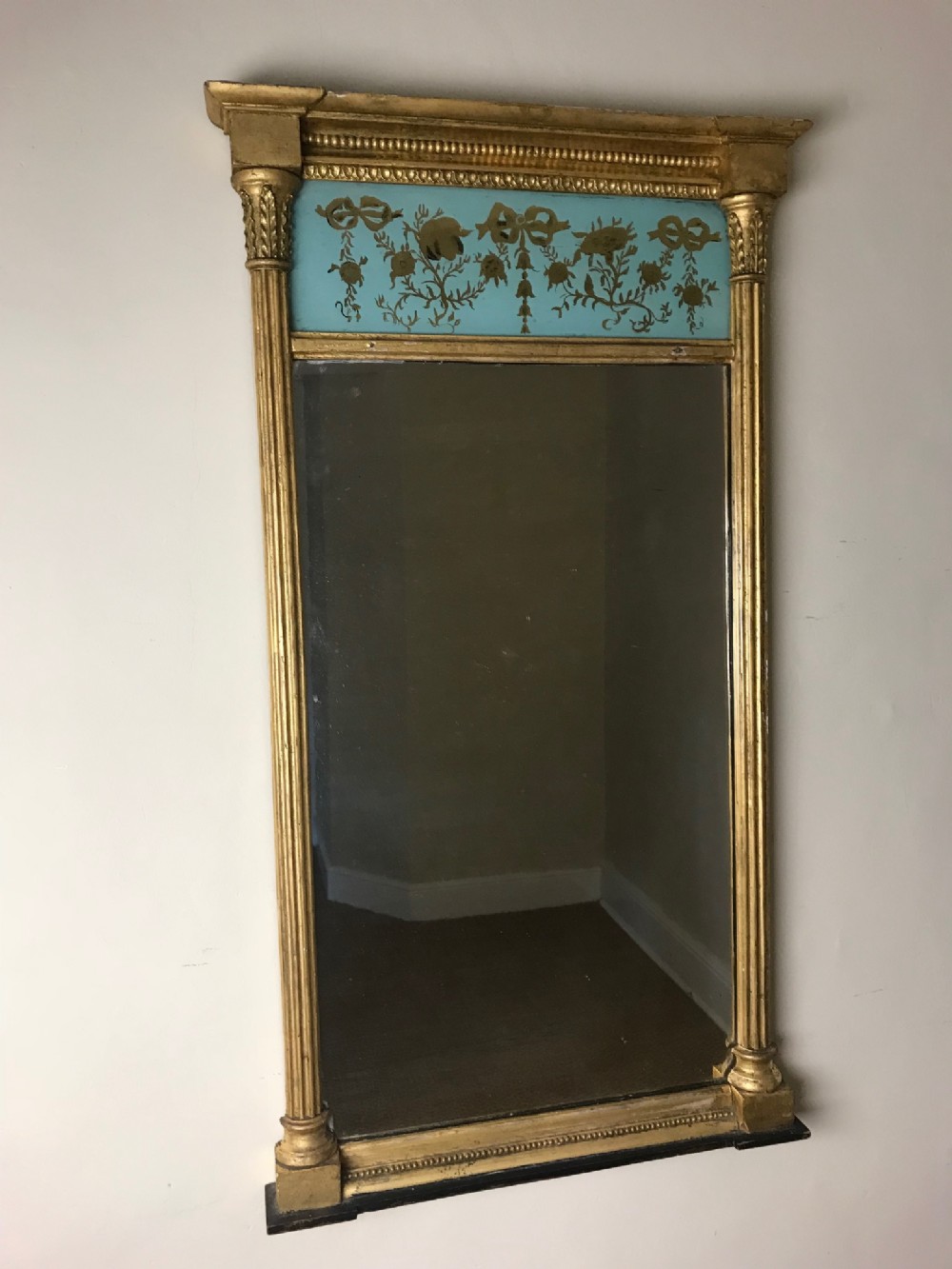 A small Regency Eglomise and gilt pier mirror circa 1820.