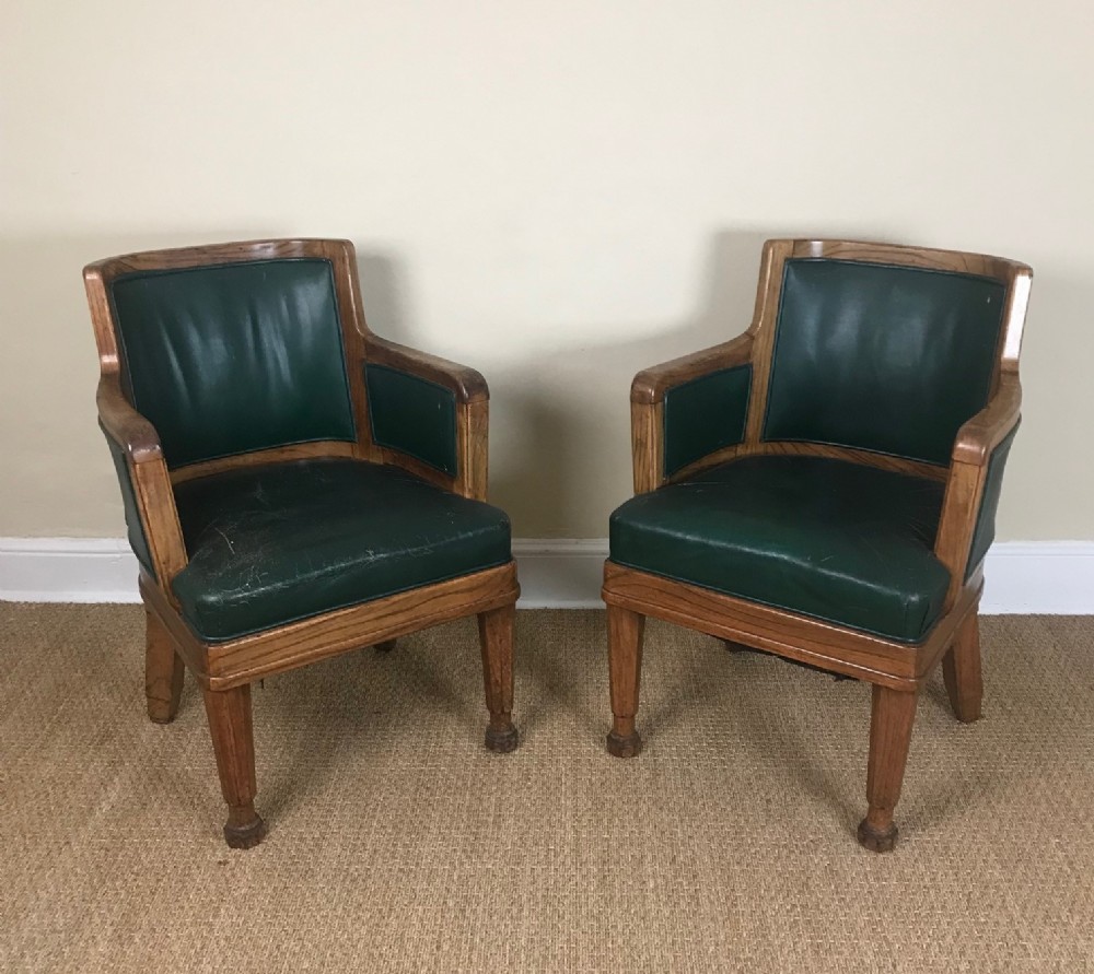 A pair of Edwardian walnut and leather library chairs circa 1910 