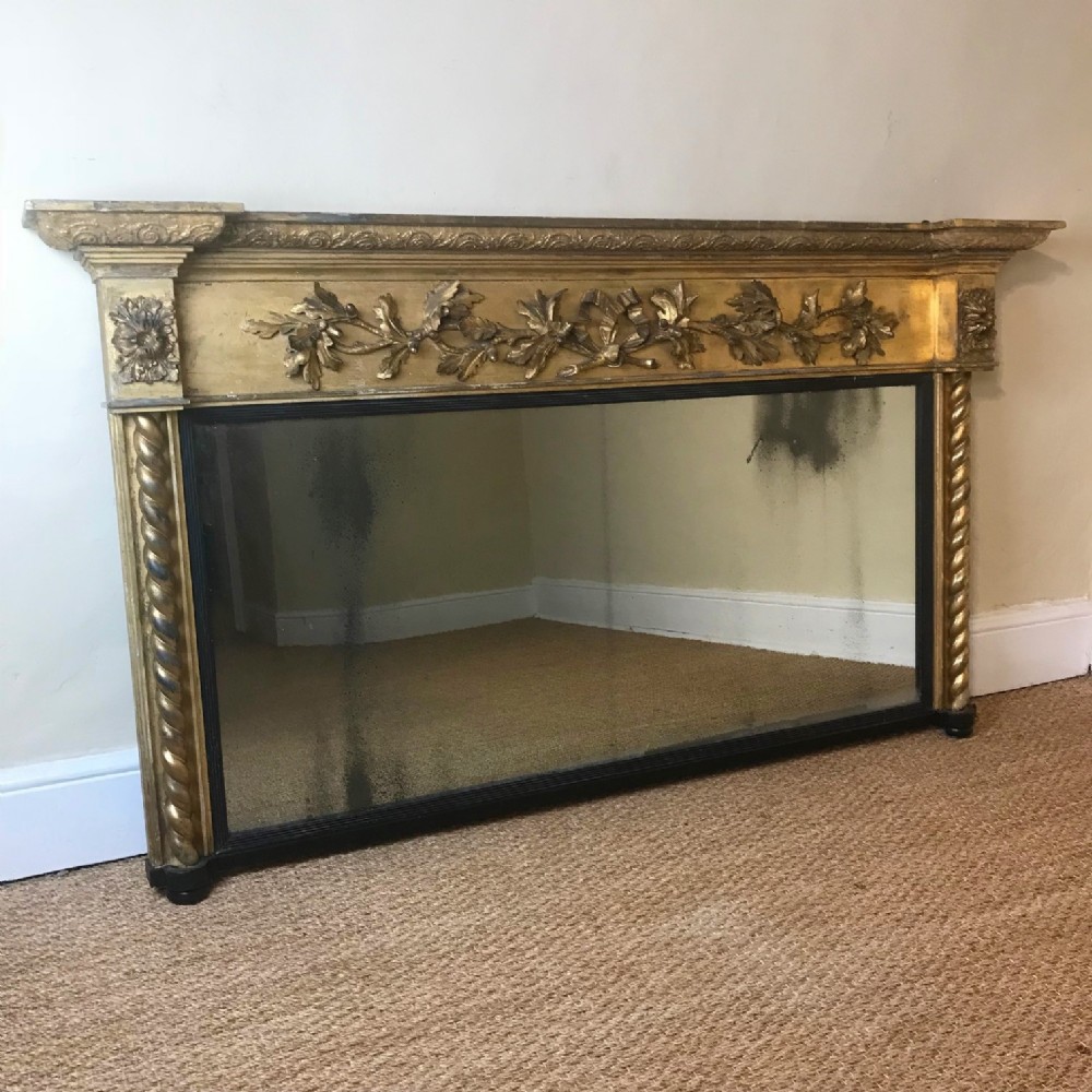 A large Regency carved giltwood overmantel mirror circa 1820 