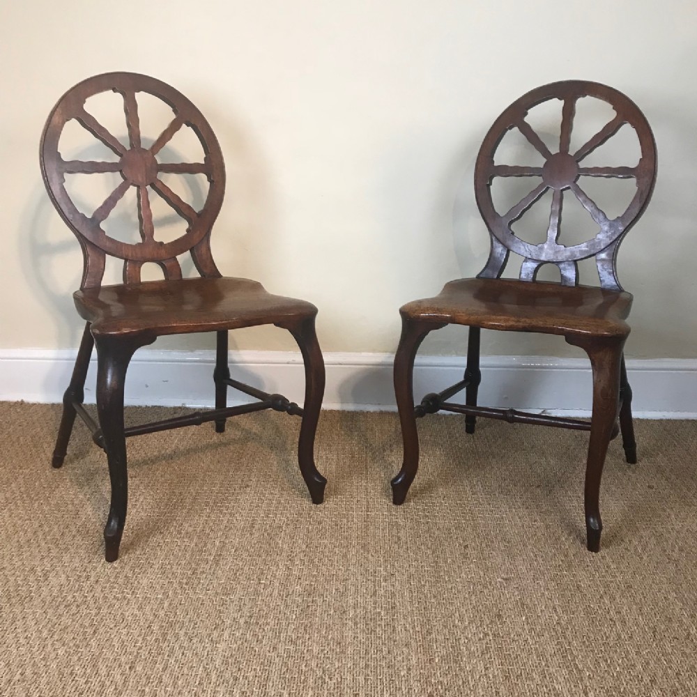 A rare pair of George 111 mahogany wheelback Windsor chairs c 1775 in the style of Ince and Mayhew