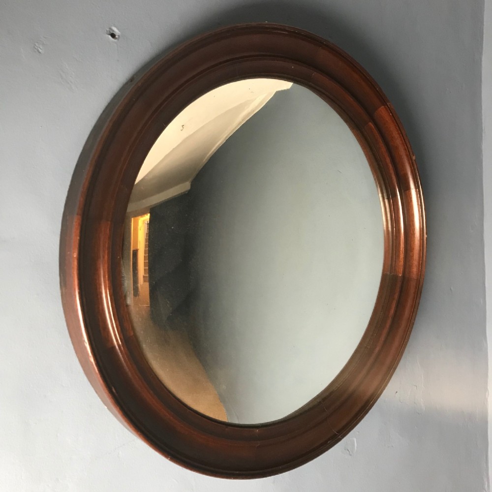 An Edwardian mahogany convex mirror circa 1910